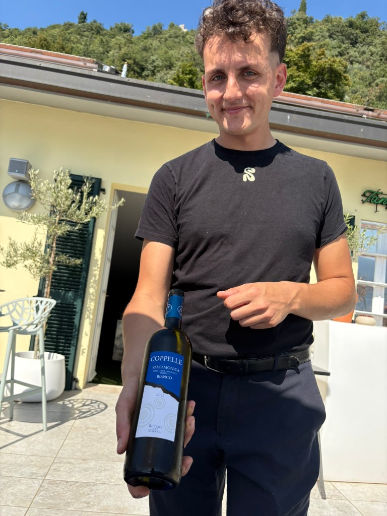 Restaurant owner displays local wine