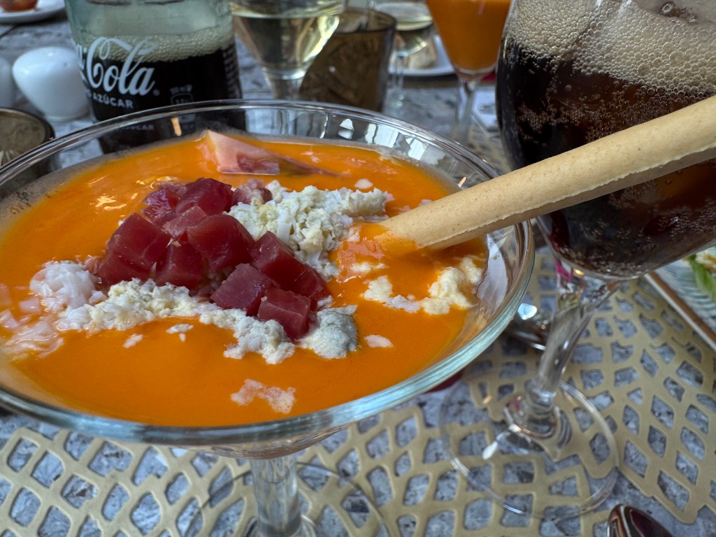 The restaurant's menu features typical local specialties, including local meats and cheeses, cold tomato soup, pastries, and fruits.