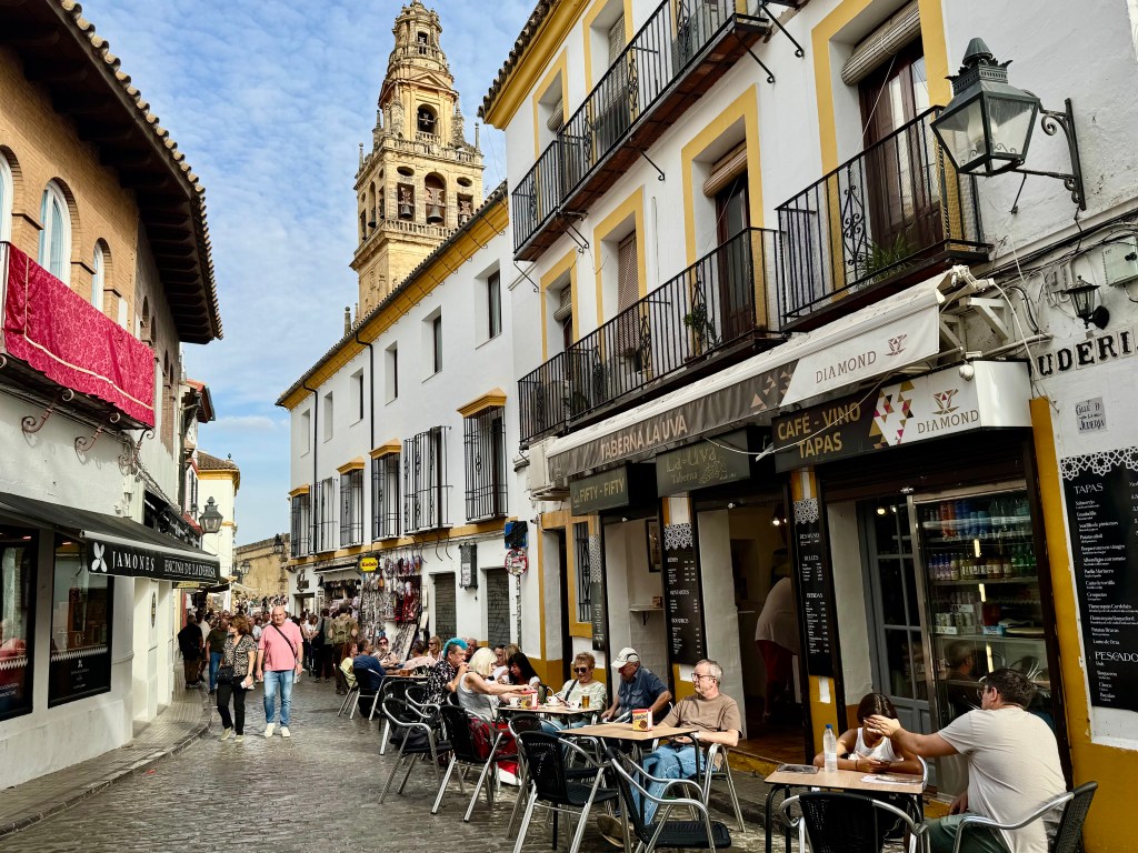 town street with people sitting at cafe tables