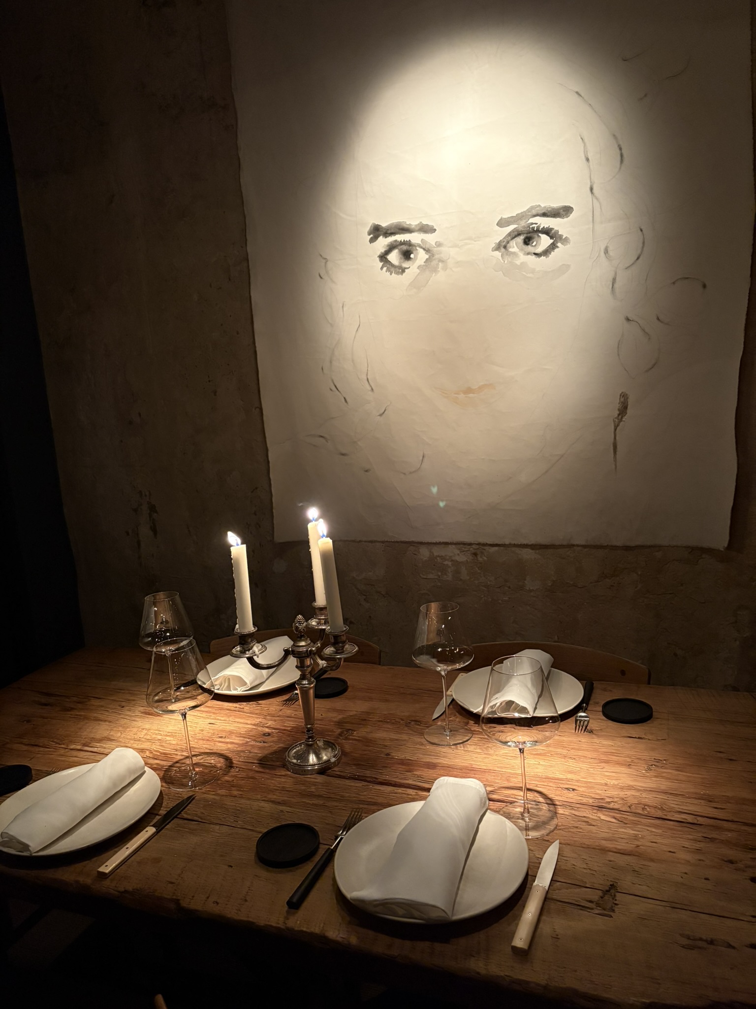 Set dinner table with painting behind it