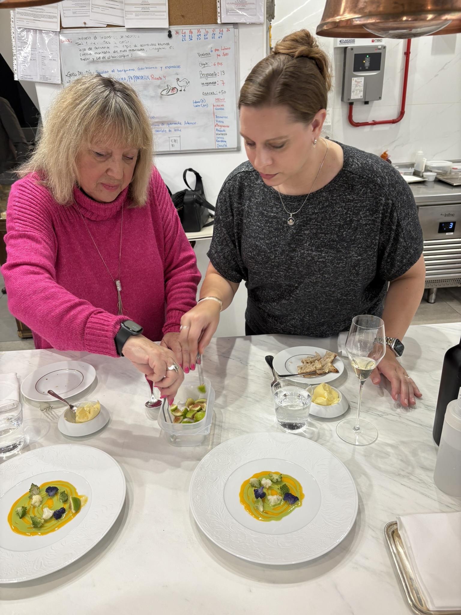 Two women plate vegetables