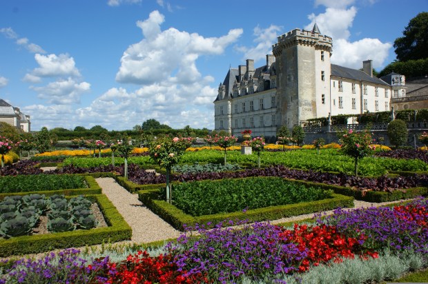 chateau surrounded by flowering gardens