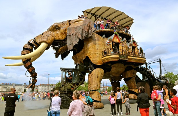 mechanical elephant with people aboard