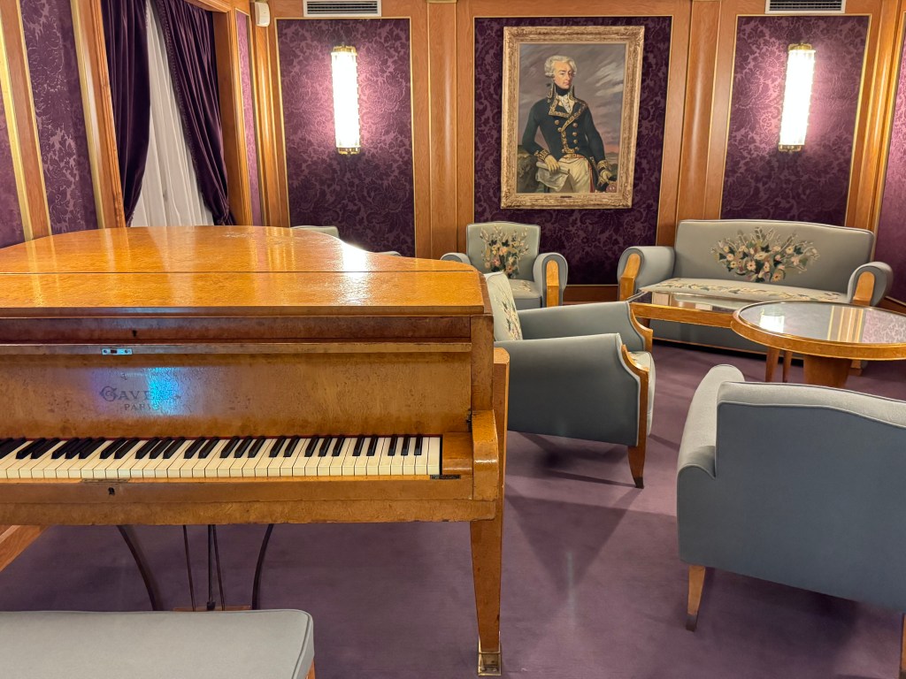 music room with piano and couches