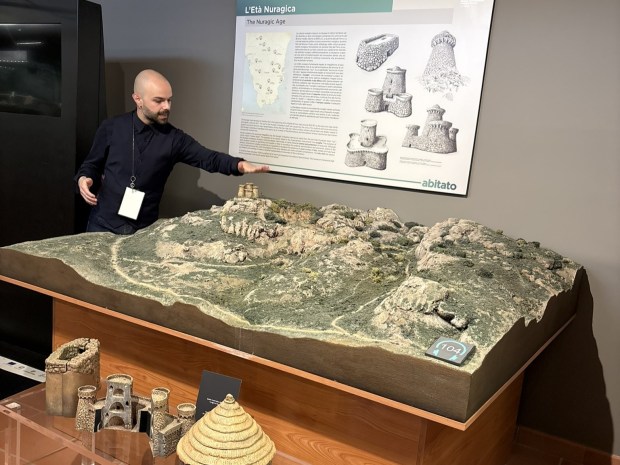 Museum guide points to exhibit model